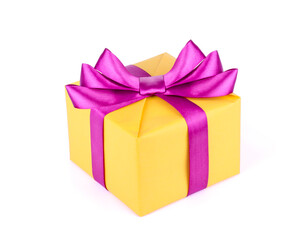 Yellow gift box with purple ribbon bow isolated on white background.