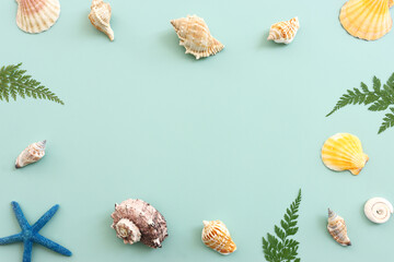 Fototapeta premium nautical concept seashells and starfish over mint blue wooden background