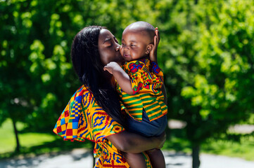 Fototapeta premium African happy mother kissing her son