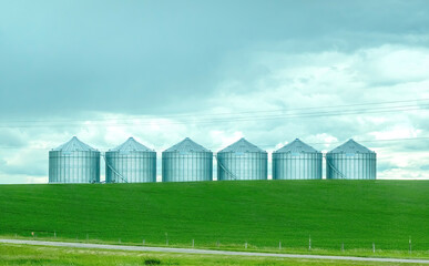 Fototapeta na wymiar Some farm grain bins on a agriculture facility in Lethbridge, Alberta, Canada.