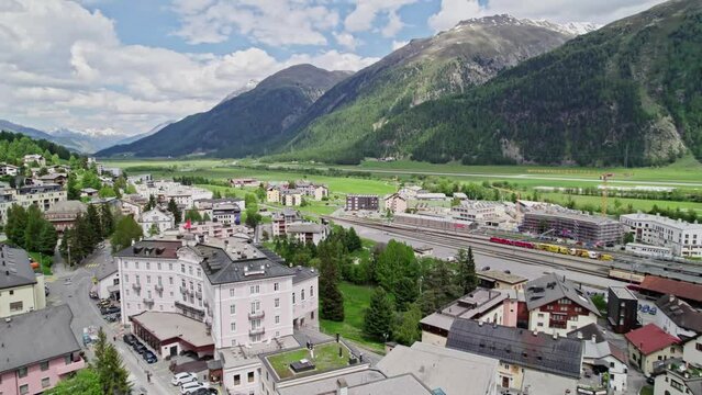 Stunning aerial view of Swiss village, Alps backdrop. Samedan, Switzerland