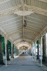 Vichy, France - 19 June 2023: Famous promenades (canopies for walking) at the Parc des Sources of Vichy
