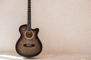 Naklejka premium Guitar. Guitar chords. Acoustic guitar. Music. Musical background. An image of an acoustic guitar. Hard light. Shadows.