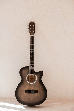 Guitar. Guitar chords. Acoustic guitar. Music. Musical background. An image of an acoustic guitar. Hard light. Shadows.