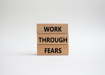 Work through fears symbol. Wooden blocks with words Work through fears. Beautiful white background. Business and Work through fears concept. Copy space.