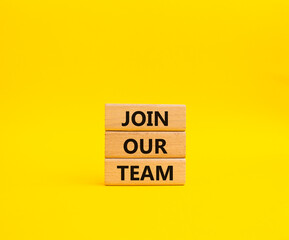 Join our team symbol. Wooden blocks with words Join our team. Beautiful yellow background. Business and Join our team concept. Copy space.