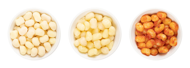 Small gnocchi, raw, boiled and with tomato sauce, in white bowls. Gnocchini are Italian dumplings,...