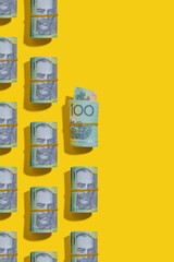 Australian dollar rolls on yellow background