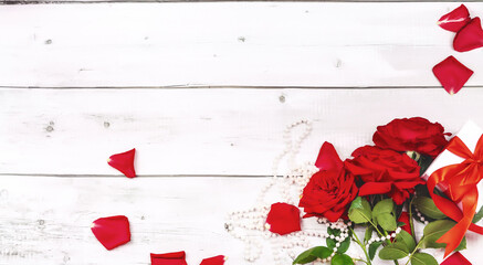 Mothers Day greeting message with red roses on white wooden background. Flat lay, top view. Happy mother's day concept.