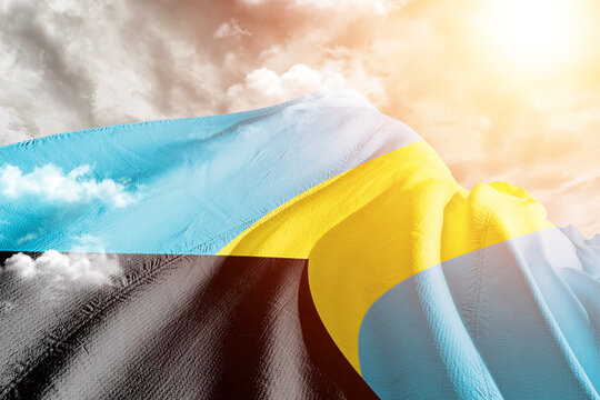 The Bahamas national flag cloth fabric waving on beautiful Cloudy Background.