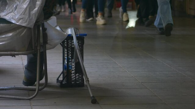 disabled homeless person in a wheelchair begging for money