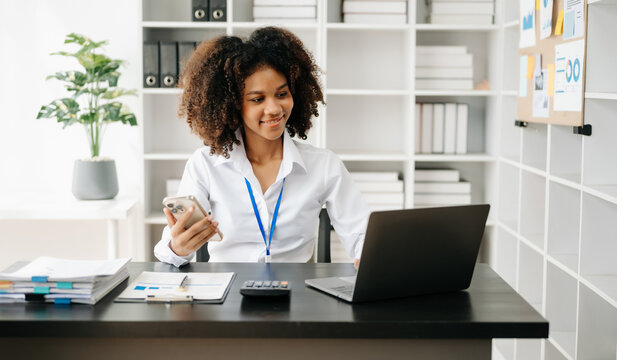 Business woman using tablet and laptop for doing math finance on an office desk, tax, report, accounting, statistics, and analytical research concept in office
