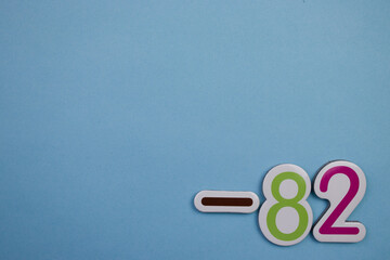 Colorful number -82, placed on the edge of a blue background.