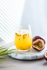 Pure passion, alcoholic cocktail with syrup, lime, orange juice, soda, ice and passion fruit