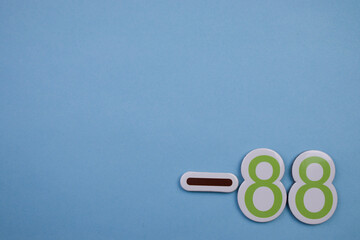 The number -88, written in color, placed on the edge of a blue background.