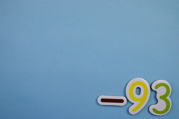 The number -93, written in color, placed on the edge of a blue background.