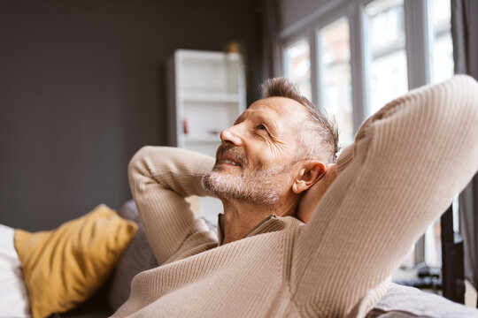 Older Man Relaxing on His Sofa, Gazing Upwards