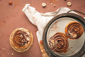 Chocolate chip muffins decorated with chocolate ganache and hazelnut