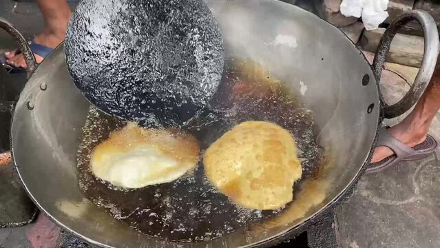 Chole Bhature Old Delhi Street Food fried in local roadside shop in India.