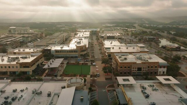 Commercial retail shopping center in suburban Austin Texas community at sunrise Aerial drone fly through