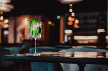 alcohol cocktail in a glass stands on a table in a bar or restaurant