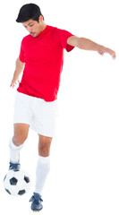 Digital png photo of biracial male football player kicking football on transparent background