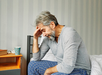 senior bed man problem home elderly mature pain bedroom upset unhappy male caucasian adult...