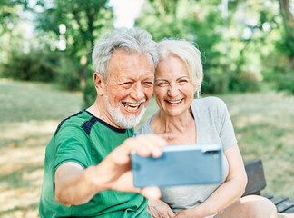 woman man outdoor senior couple happy lifestyle retirement together love elderly video call selfie photo mobile smartphone communication phone sport active fitness outfit training healthy