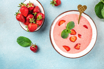 Sweet creamy strawberry soup on a light background. top view