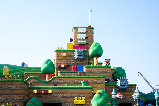 Japan - April 03, 2023: Mario flag check point game stage challenge pixel block design and crane truck development in Super Nintendo World of Mario Bros amusement park Universal Studios Japan, Osaka