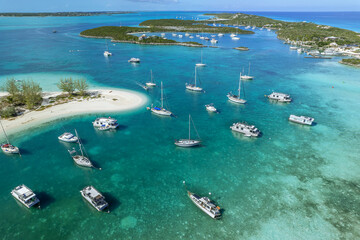 Drone aerial view of anchored sailing yacht in emerald Caribbean Sea, Stocking Island, Great Exuma, Bahamas.