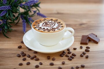 Obraz na płótnie Canvas Hot mocha in white cup, foam decorated with caramel