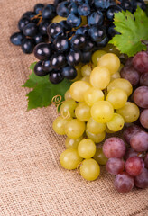 Bunches of fresh ripe red grapes on a wooden textural