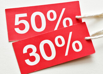 30%, 50% discount on red tag and white background. Concept in business - time for discounts and promotions.