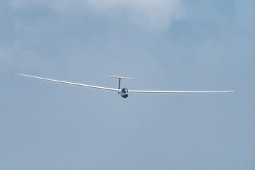 Glider plane flying in the clouds