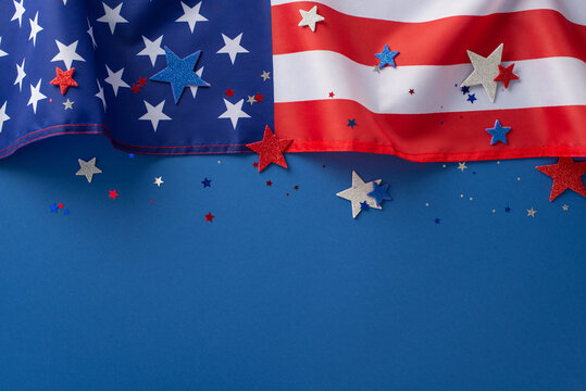Labor Day in USA concept. Above view photo of empty space with white, blue and red star-shaped sparkles and american flag at the top on blue isolated background with copy-space