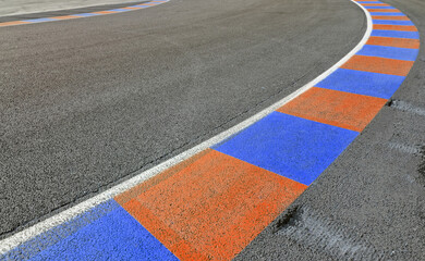 wide background of a colorful curve of a motor racing circuit. Road asphalt texture for motor sports design.