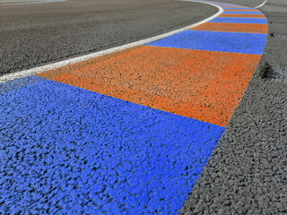Fototapeta na wymiar markings on the ground on a bend in a racing circuit track. Motor sports background