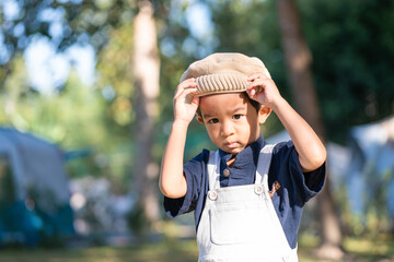 Happy kindergarten asian boy camping in forest camp site