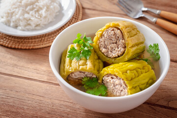 Bitter gourd with minced pork soup in bowl and rice on plate.