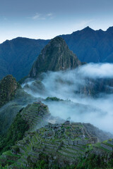 Machu Picchu and strip fog in the morning, an Inca city was found in 1911. The mountain Huayna Picchu rises behind it.