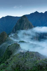 Foto op Canvas Machu Picchu and strip fog in the morning, an Inca city was found in 1911. The mountain Huayna Picchu rises behind it. © Theerayoot