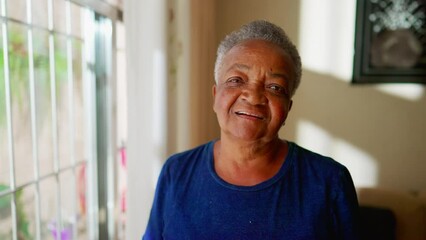 One happy black senior woman looking at camera smiling. A Brazilian African American elderly lady joyful expression, close-up face - Powered by Adobe