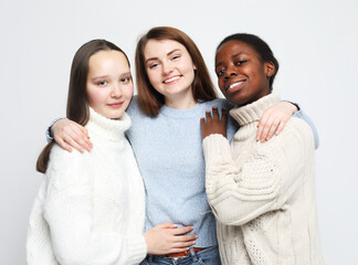 girls friends of different nationalities over grey background