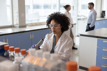 Female scientist using a microscope in laboratory 