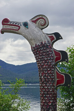 Ketchikan, Alaska: A totem overlooks the Tongass Narrows at Potlatch Totem Park, a recreated Tlingit village with totems, carving shed, and historical displays.