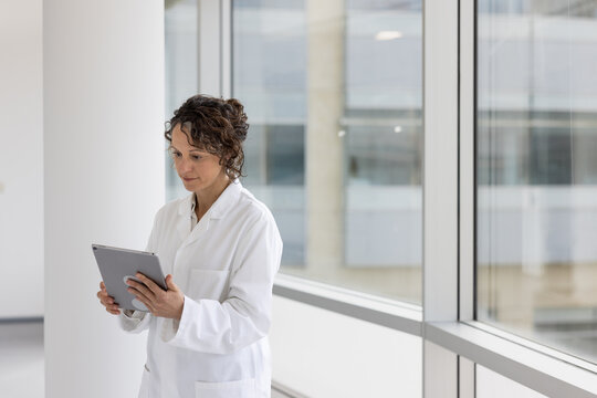 Female doctor looking a patient results in a hospital using a digital tablet