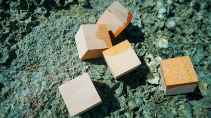 Mockup wooden cubes on on the beach sand. Free space wooden cubes for your text.