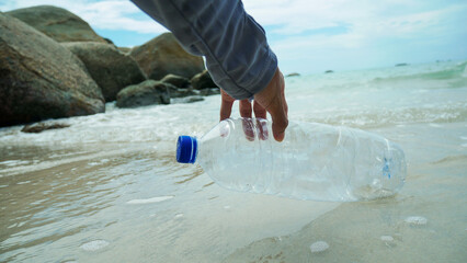 Volunteer man and Plastic water bottles pollution in ocean. Environmental pollution Ecological problem
