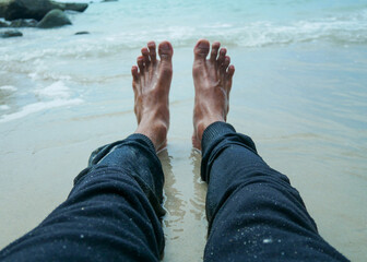 Closeup male feet on the beach. travel, tourism, vacation, people and summer holidays concept